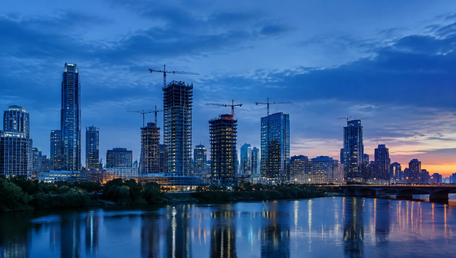 City skyline with tower cranes over construction